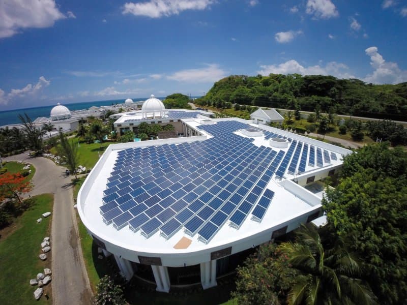 Aerial view of completed commercial solar installation on a hotel rooftop in Nigeria showing 150kw panel array